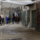 People walk down an empty street during a full strike in Hebron, West Bank.